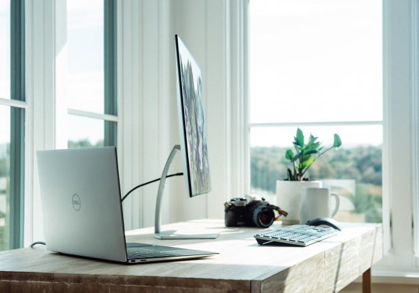 silver macbook on white table