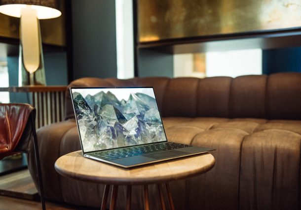 laptop on brown sofa