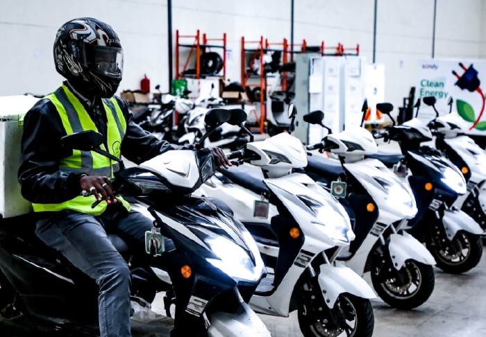 A man sits on an electric motorbike