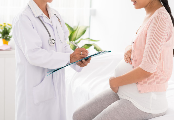 A pregnant woman visits a doctor's surgery