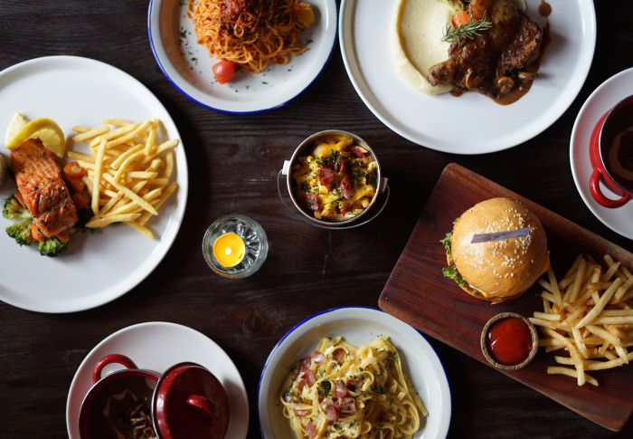A collection of common western dishes on a wooden table.
