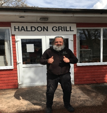 Marc, standing outside the Haldon Grill, where he works