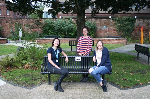 Happy to Chat Bench at Coronation Garden near Town Hall in Penrith. Left to right: Lucy Fawcett, NCIC Wellbeing Coach; Sophie Dickinson, NCIC Wellbeing Coach; Cllr Lissie Sharp, Communities Portfolio Holder at Eden District Council