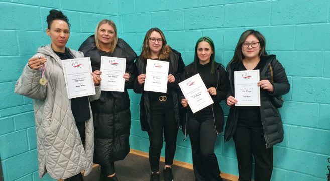 Five female students holding certificates