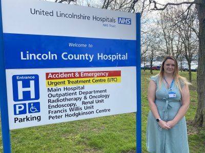 Lucy Holt stood next to a Lincoln County Hospital sign