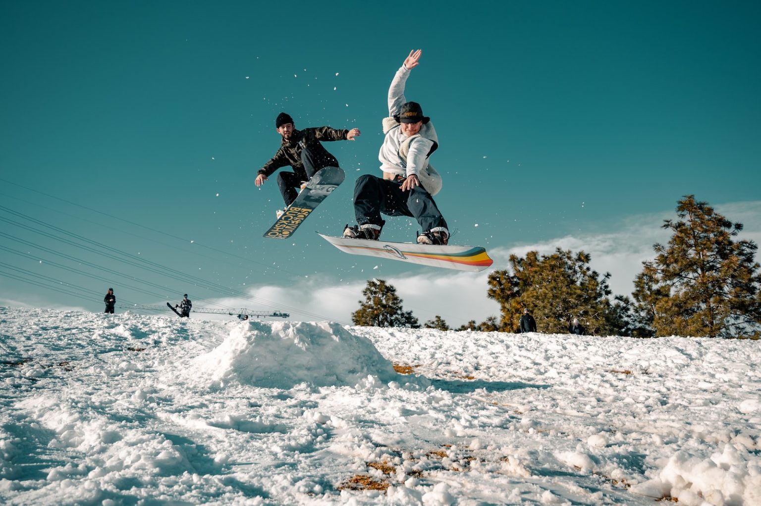 The Most Spectacular Tricks From the Winter Olympics man in black and white jacket riding on snowboard during daytime