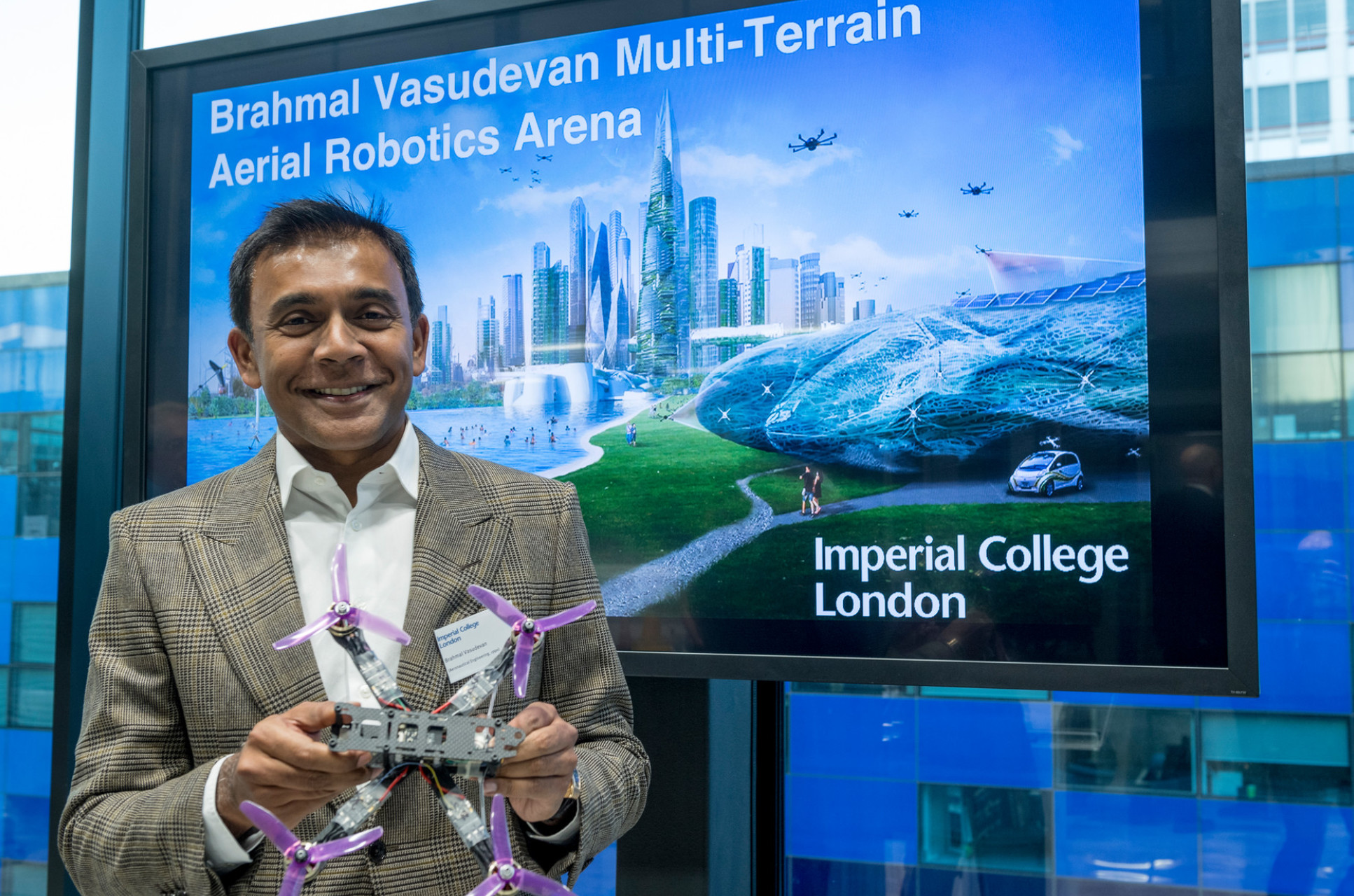 Brahmal Vasudevan holding a drone at the launch of the the Brahmal Vasudevan Multi-Terrain Aerial Robotics Arena