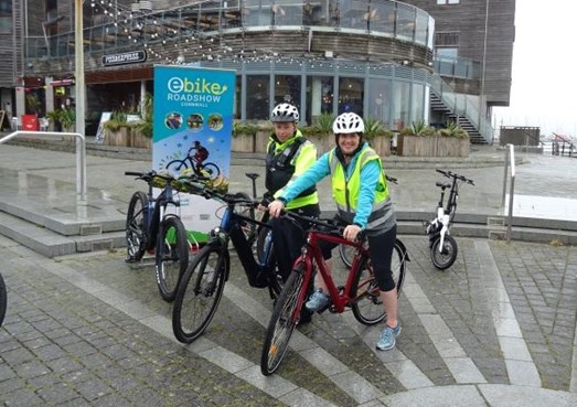 Active travel minister Trudy Harrison tries a Cornwall Council e-bike with a Devon & Cornwall Police officer