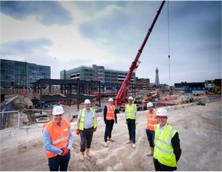 Talbot Gateway -  Development team in safety gear with steel structure of new Holiday Inn being built