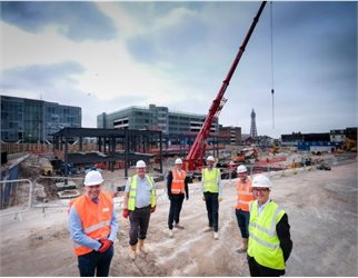 Talbot Gateway - Development team in safety gear with steel structure of new Holiday Inn being built