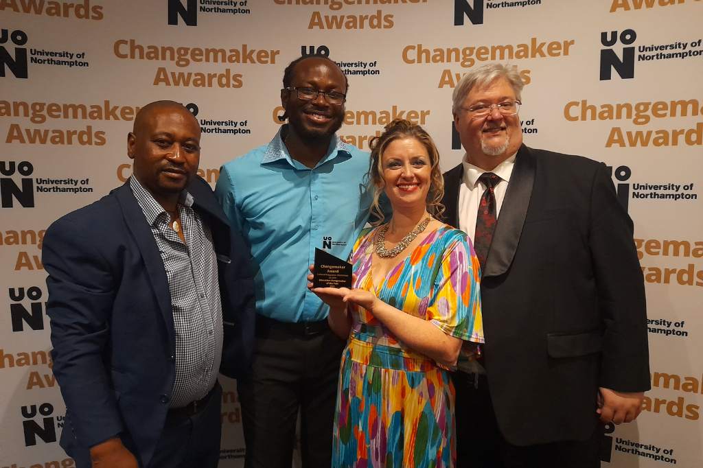 Group of four people and their awards trophy
