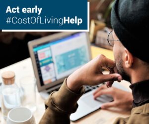Image of person accessing cost of living help online.