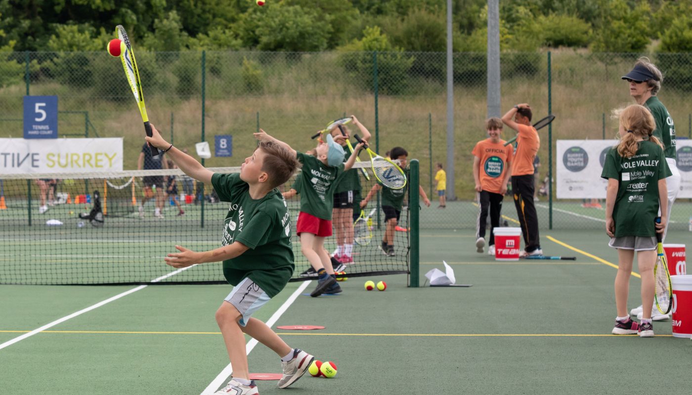 Photo of children taking part in a tennis activity for Surrey Youth Games 2022