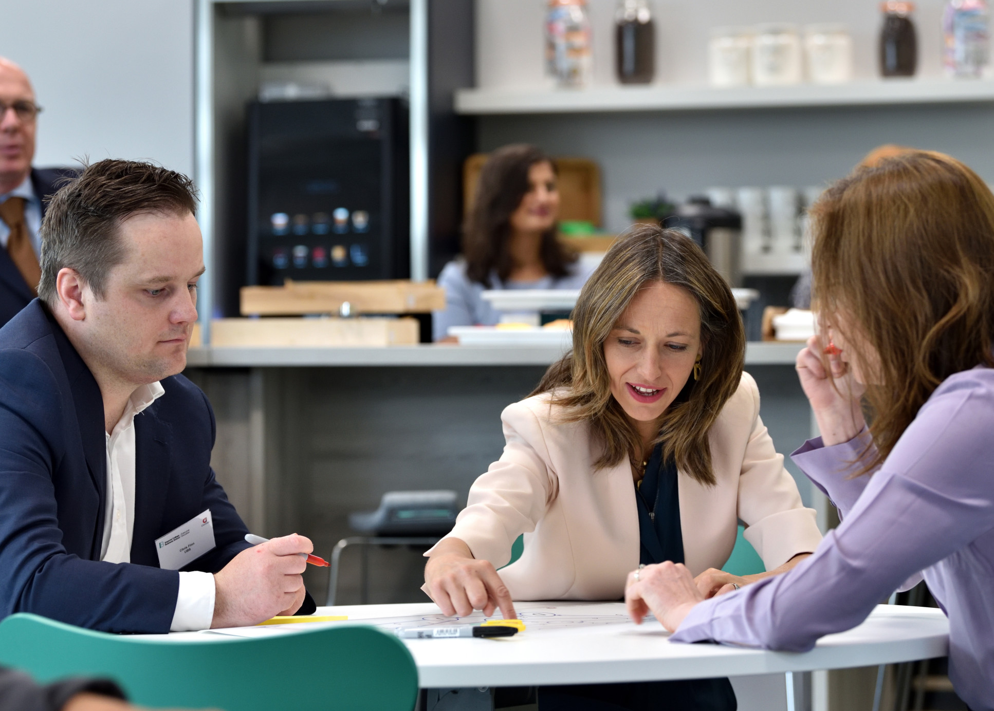 Minister Whately working with an apprentice on a data science activity