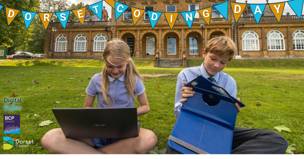 The text in the picture reads Dorset Coding Day. There are two children smiling and looking at a laptop and a tablet
