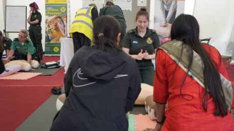 LAS staff teaching two women how to perform CPR