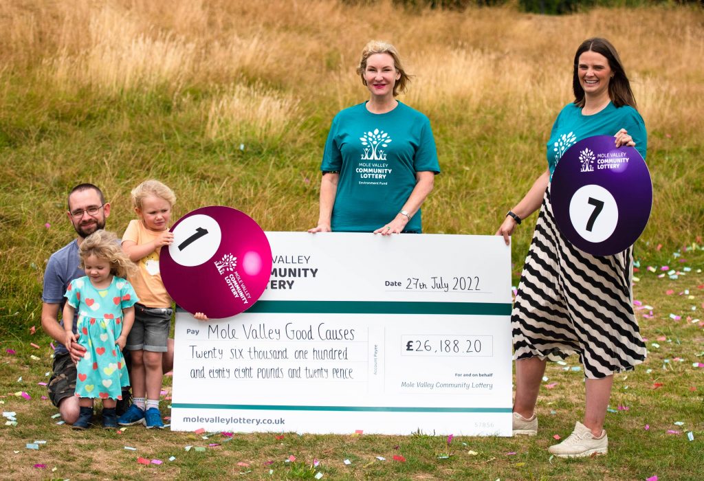 Councillor Claire Malcolmson and representatives from Dorking Nursery with a large cheque.