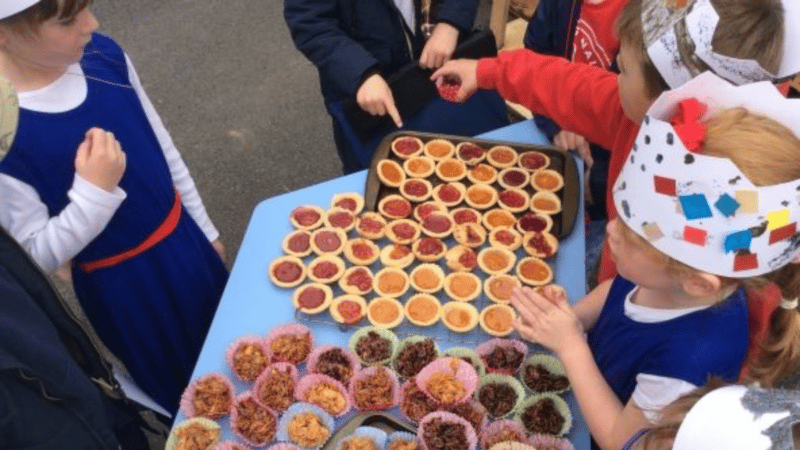 Children at Swimbridge C of E Primary School with jam tarts and crispy cakes that they've made