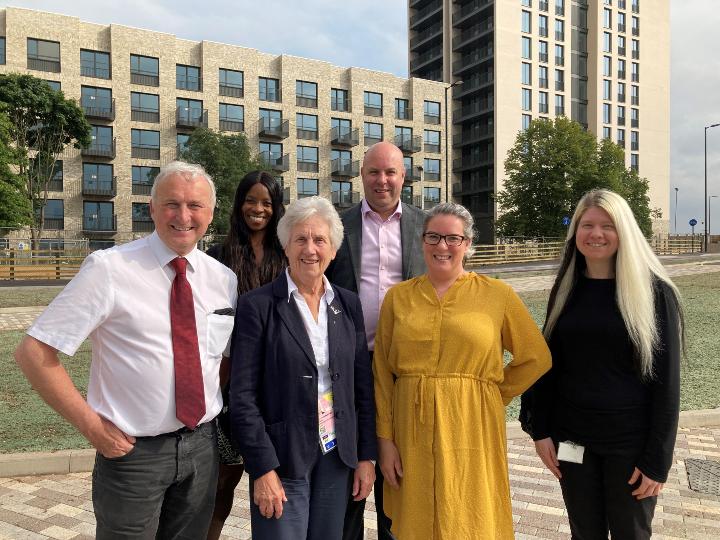 Dame Louise Martin, Cllr Ian Ward and other council officers in front of new housing in Perry Barr