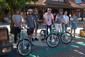 Beryl and Dorset Council representatives at a Beryl Bikes bay in Ferndown
