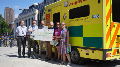CEO Daniel Elkeles with NHS England EPRR team holding their cheque for the London Ambulance Charity