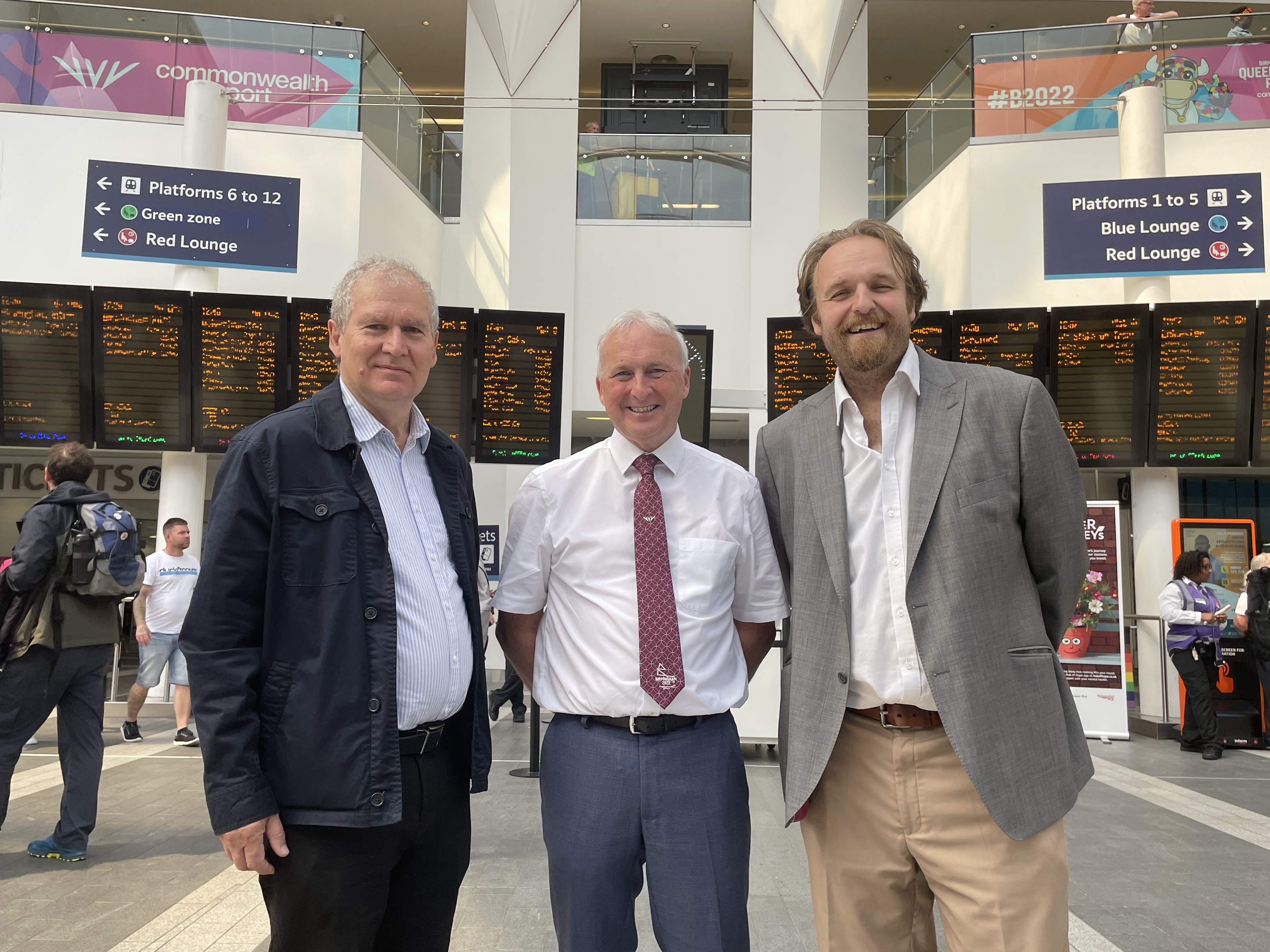 Three politicians standing in New Street station