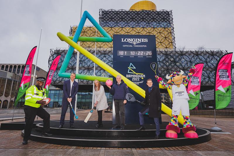 Representatives of the organisations delivering Birmingham 2022 stood in front of the Countdown Clock in front of the Library of Birmingham