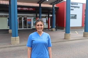 A&E nurse Danielle Jamieson in her uniform standing outside of Urgent Care at North Tees