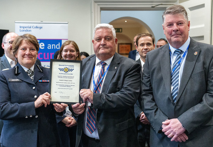 Commander Harper presenting the Secured Environments certificate to Terry Branch and Nigel Ward of the College's Security team