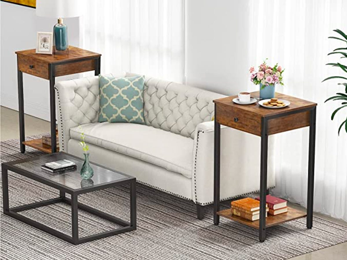 Two Ecoprsio Nightstands staged on each end of a sofa in a living room setting.