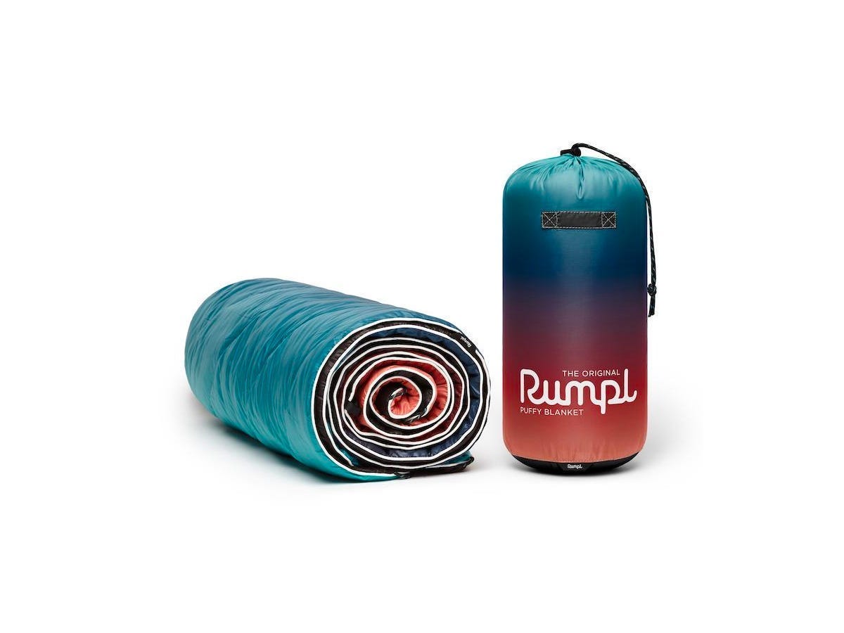 Cyber Monday 2022 Rumpl blanket deal: A rolled Rumpl Original Puffy Blanket on a flat white background.