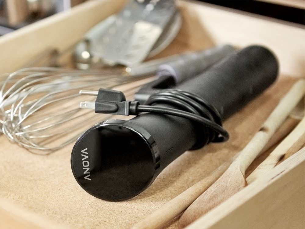 anova precision cooker nano sous vide laying in a drawer next to other kitchen utensils.