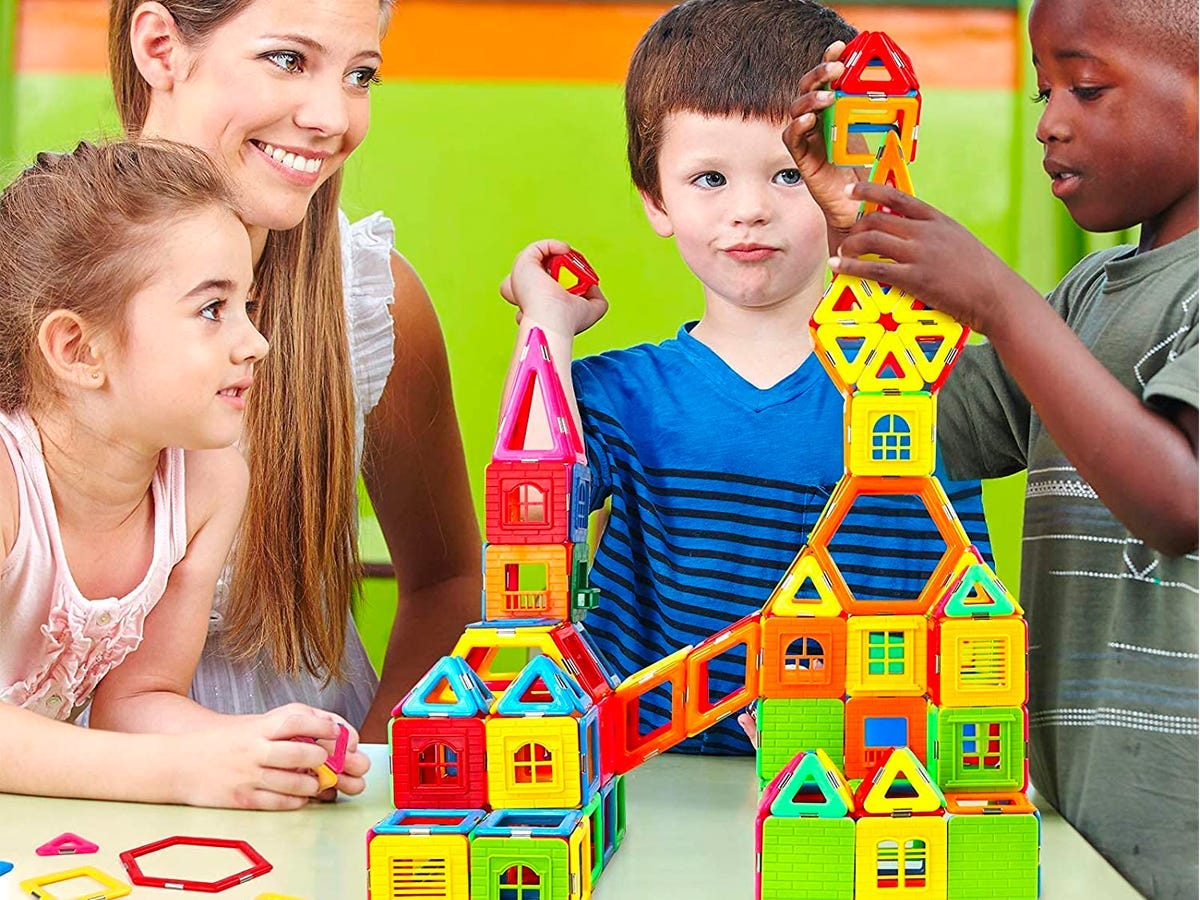 A group of kids building a structure with the Coodoo Magnetic Blocks.