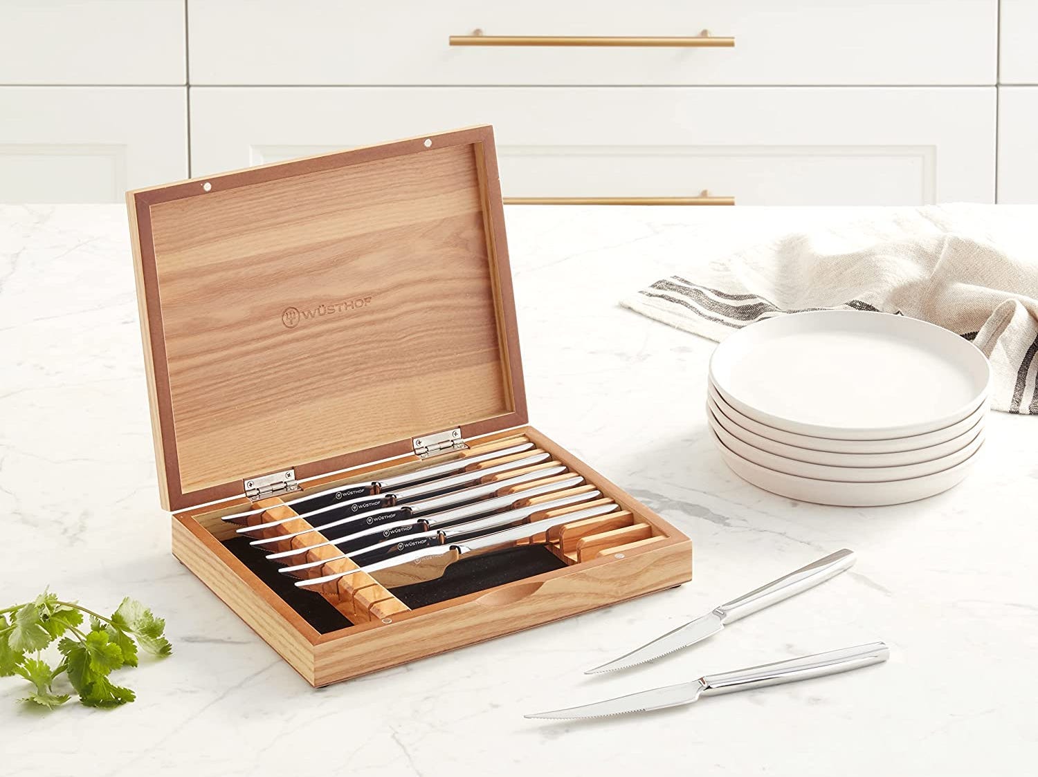 a set of Wüsthof Stainless-Steel Steak Knives sitting on a kitchen counter