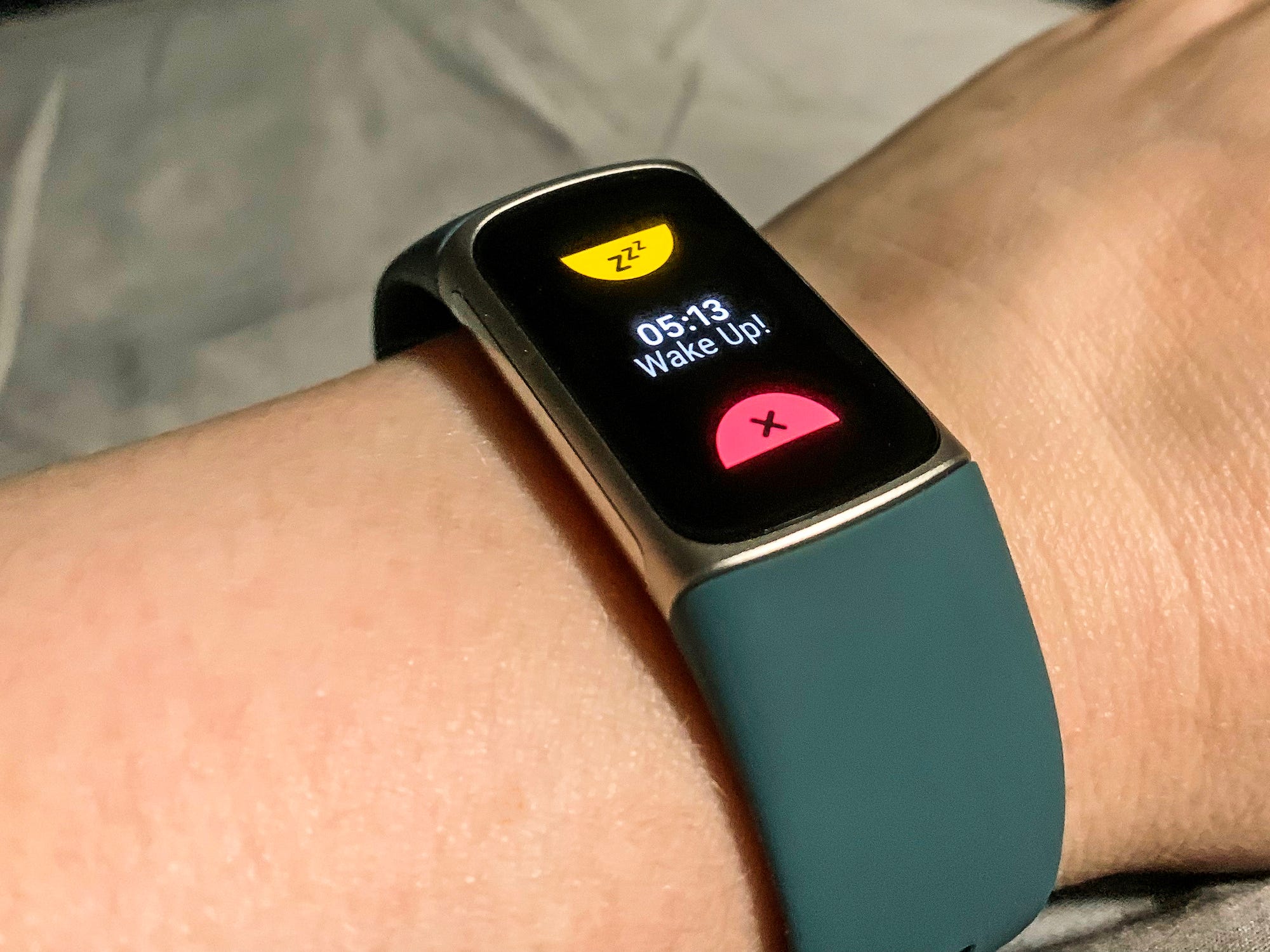 A person is wearing a Fitbit Charge 5 on their wrist, one of the best gift ideas on sale for Cyber Monday.