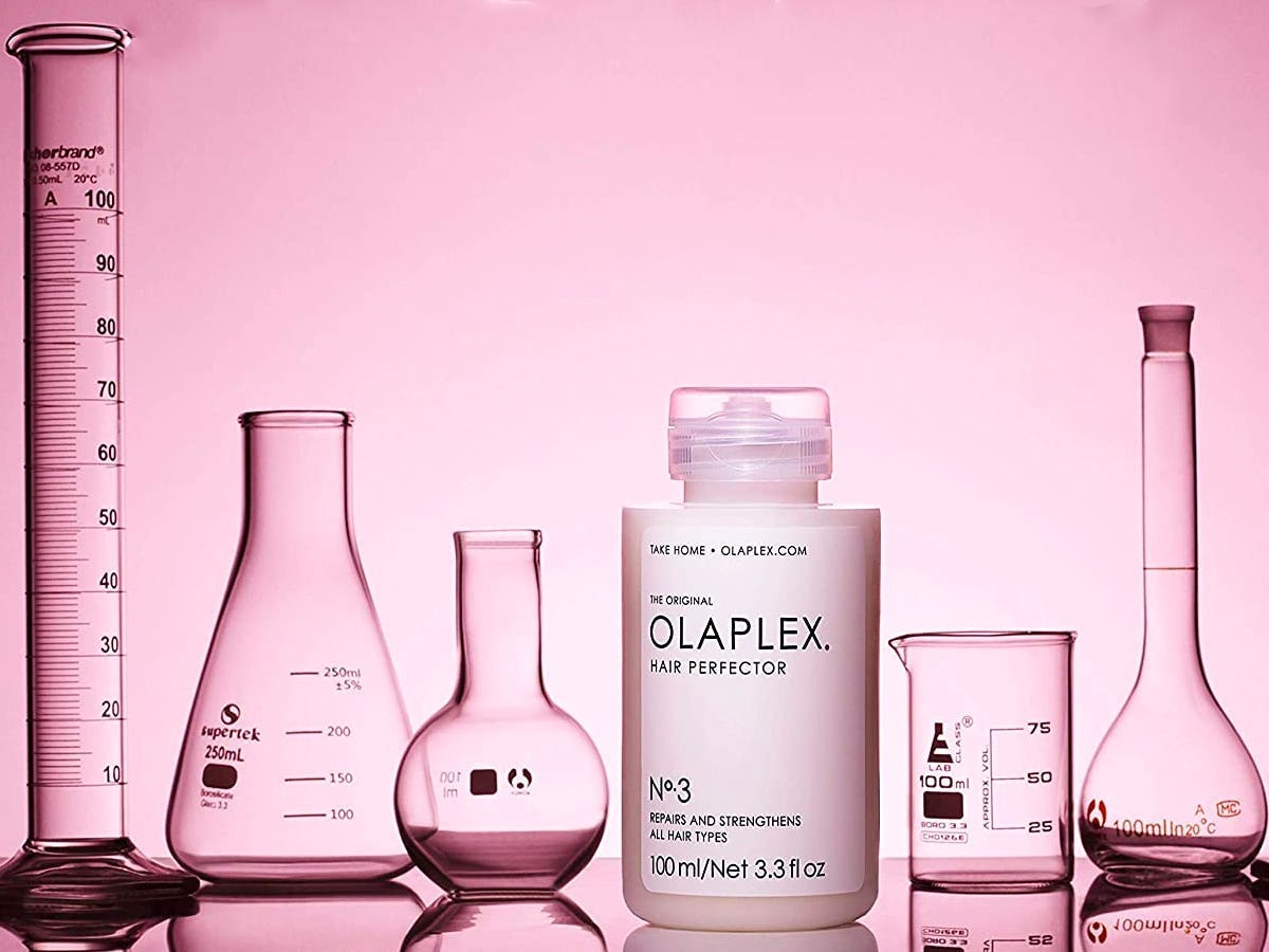 Five beakers surrounding the Olaplex Hair Perfector No 3 Repairing Treatment, one of the clever gift ideas on sale for Cyber Monday