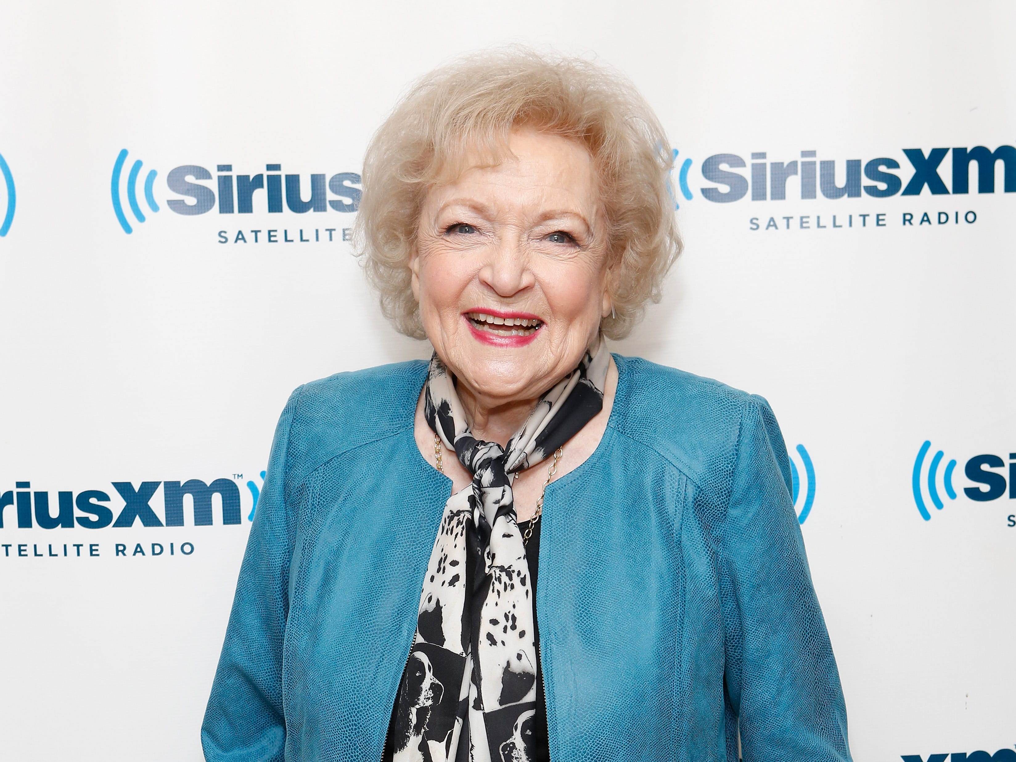 Betty White in a teal jacket