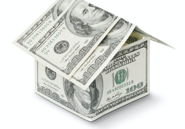 a house made out of money on a white background