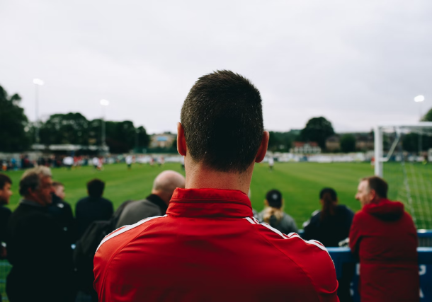 Man watching a football match with excitement and anticipation