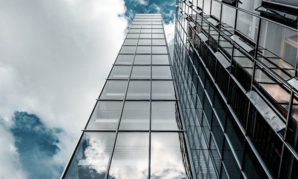 low angle photography of high rise building under cloudy sky