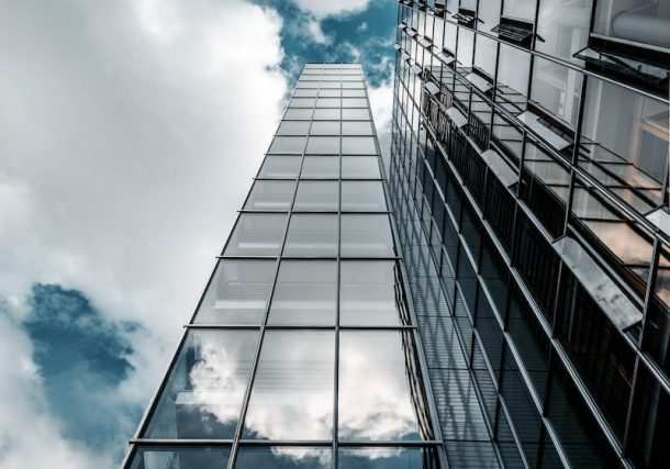 low angle photography of high rise building under cloudy sky