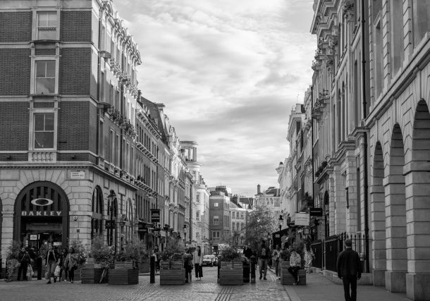 grayscale photo of people in square