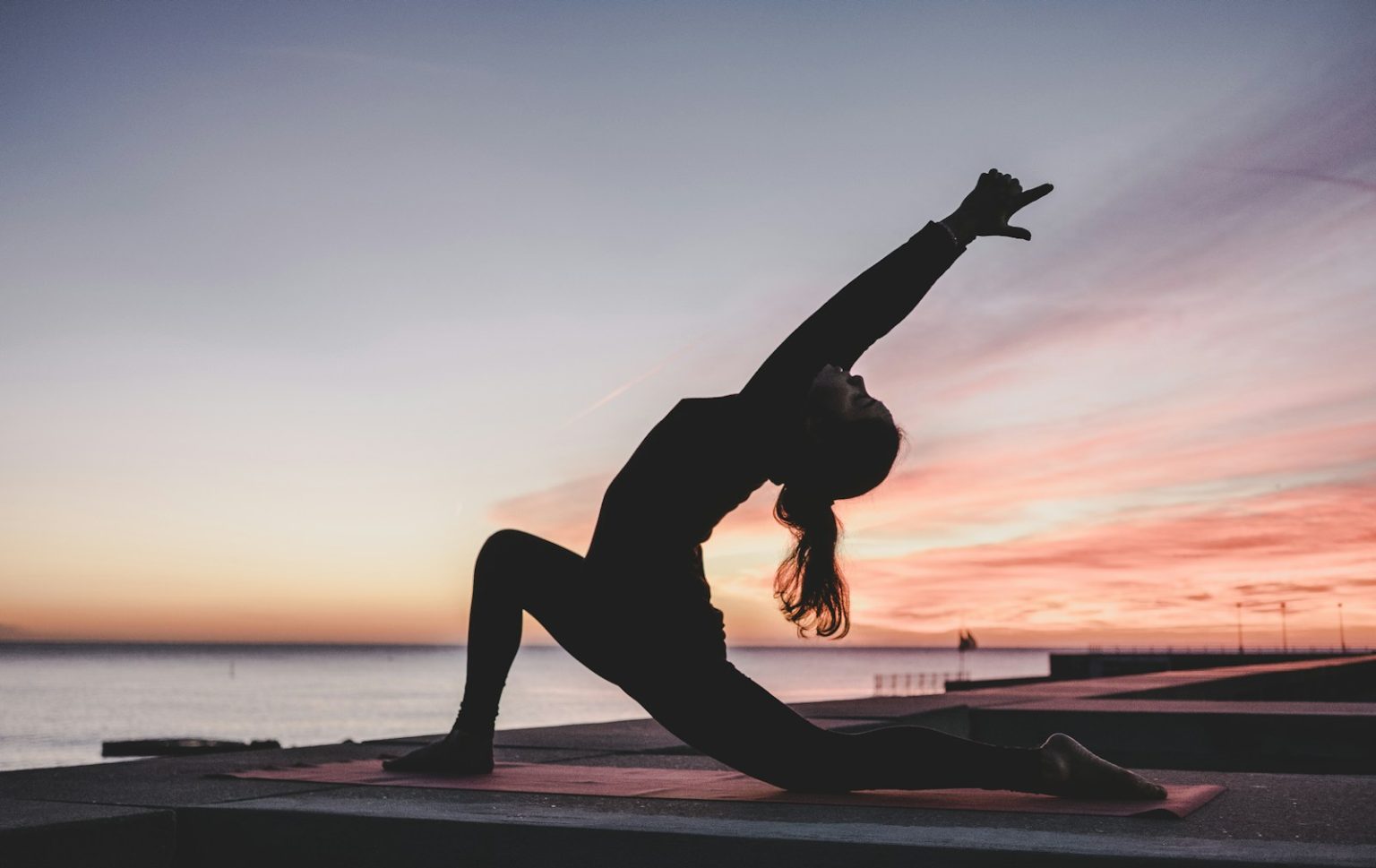 Unlock the Benefits of Yoga: A Beginner’s Perspective silhouette photography of woman doing yoga