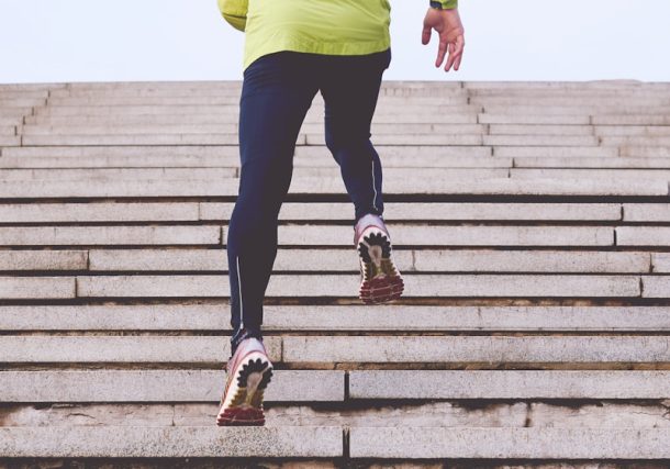 person climbing concrete stairs