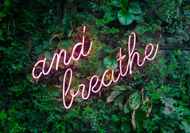 and breathe neon sign on tre