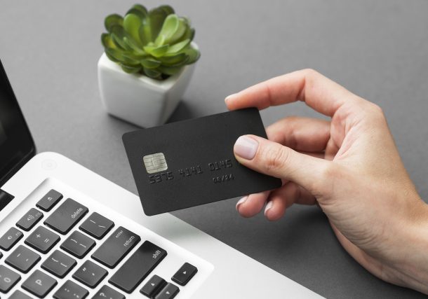 A person holding a Credit Card trying to use benefits while spending online