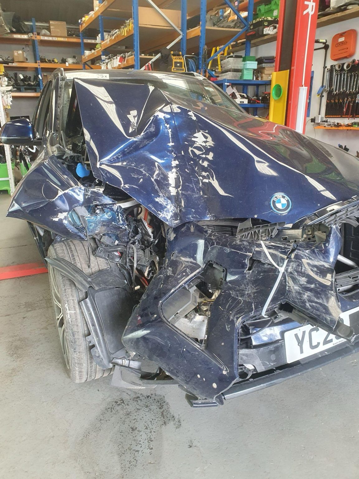 Inside a BMW Breakers Yard, MT Auto Parts: What Happens After a Car Arrives? Accident-damaged BMW waiting to be dismantled inside a BMW breakers yard