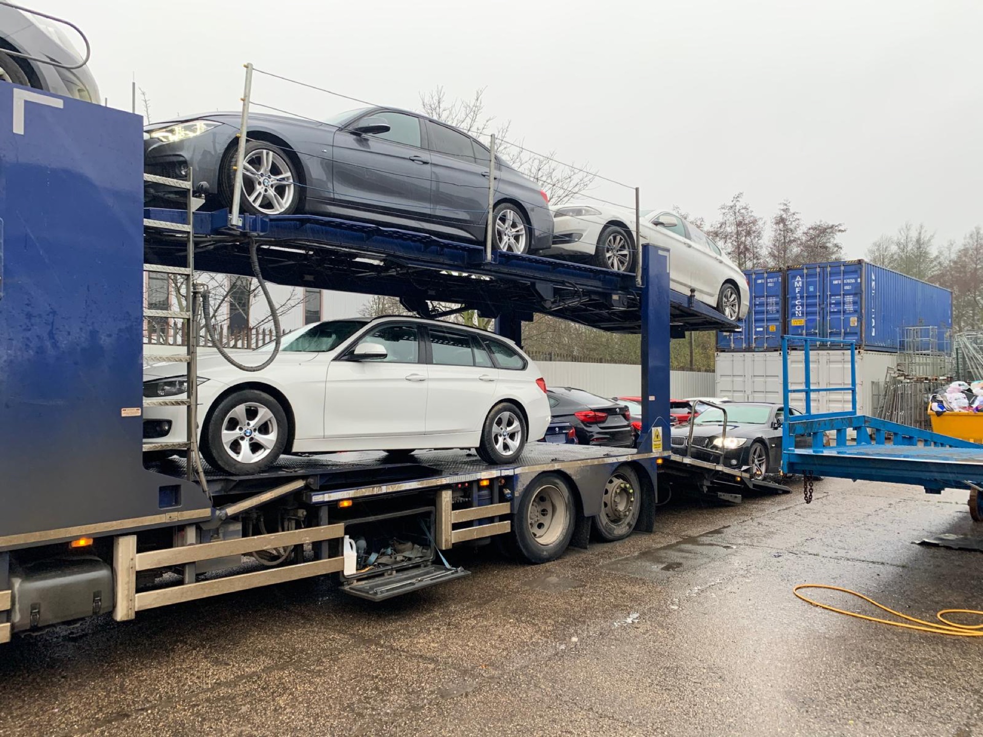 Car transporter unloading used BMWs at a BMW breakers yard