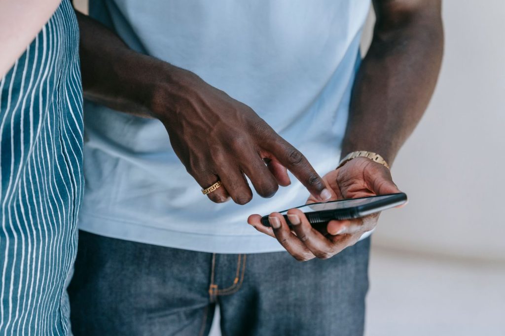4 Top Sites to Buy Instagram Followers (100% Real) Hands using a smartphone to browse social media