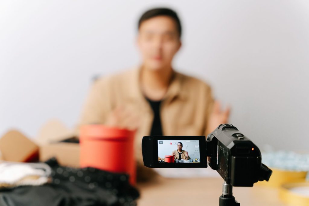 5 Sites to Buy YouTube Subscribers – All Working Platforms A creator recording a video in front of a camera